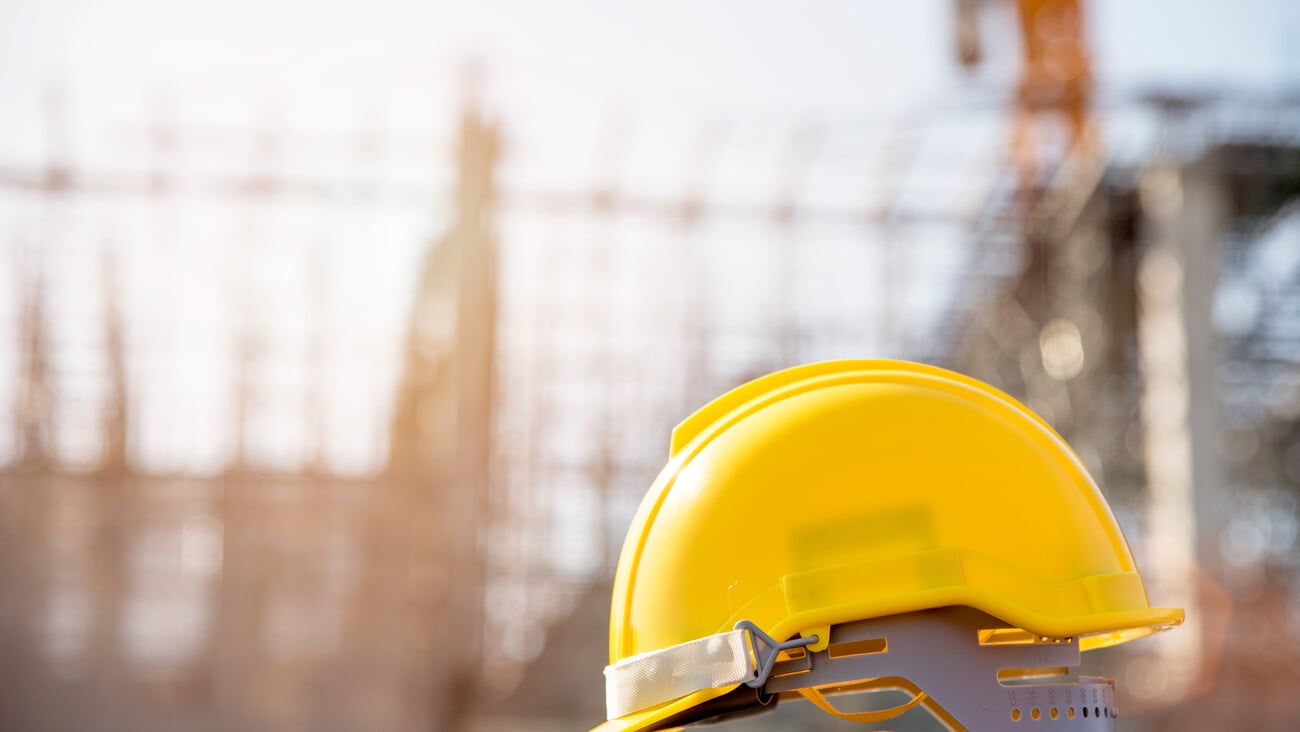 helmet in construction site and construction site worker background  safety first concept; Shutterstock ID 762827557