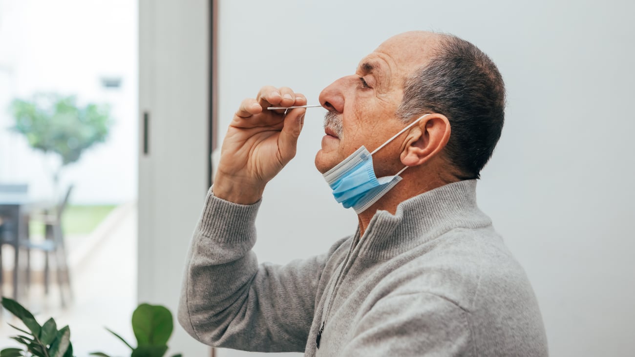 Man administering COVID test at home