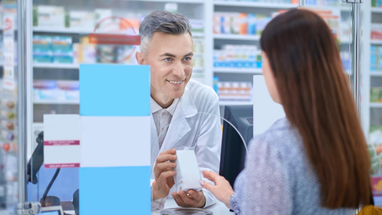 pharmacist helping a woman with healthcare advice