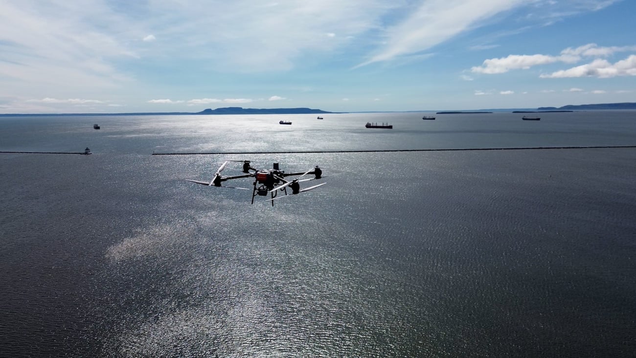 A drone flies over the water