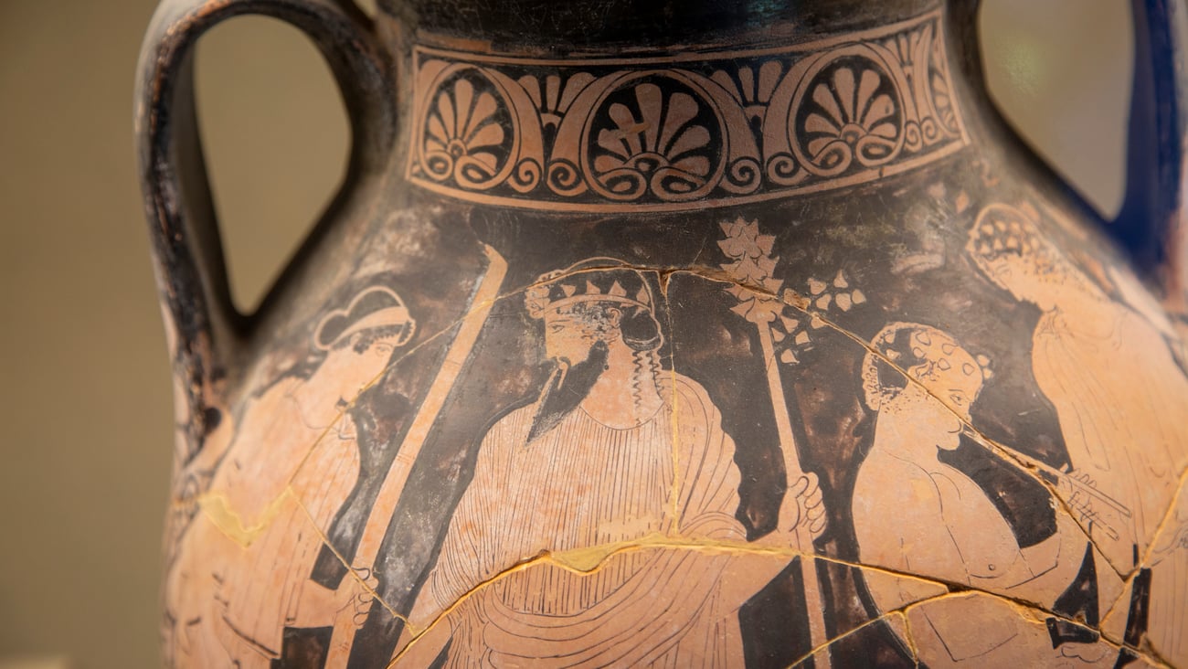 An ancient Greek vase depicting a scene of people chatting