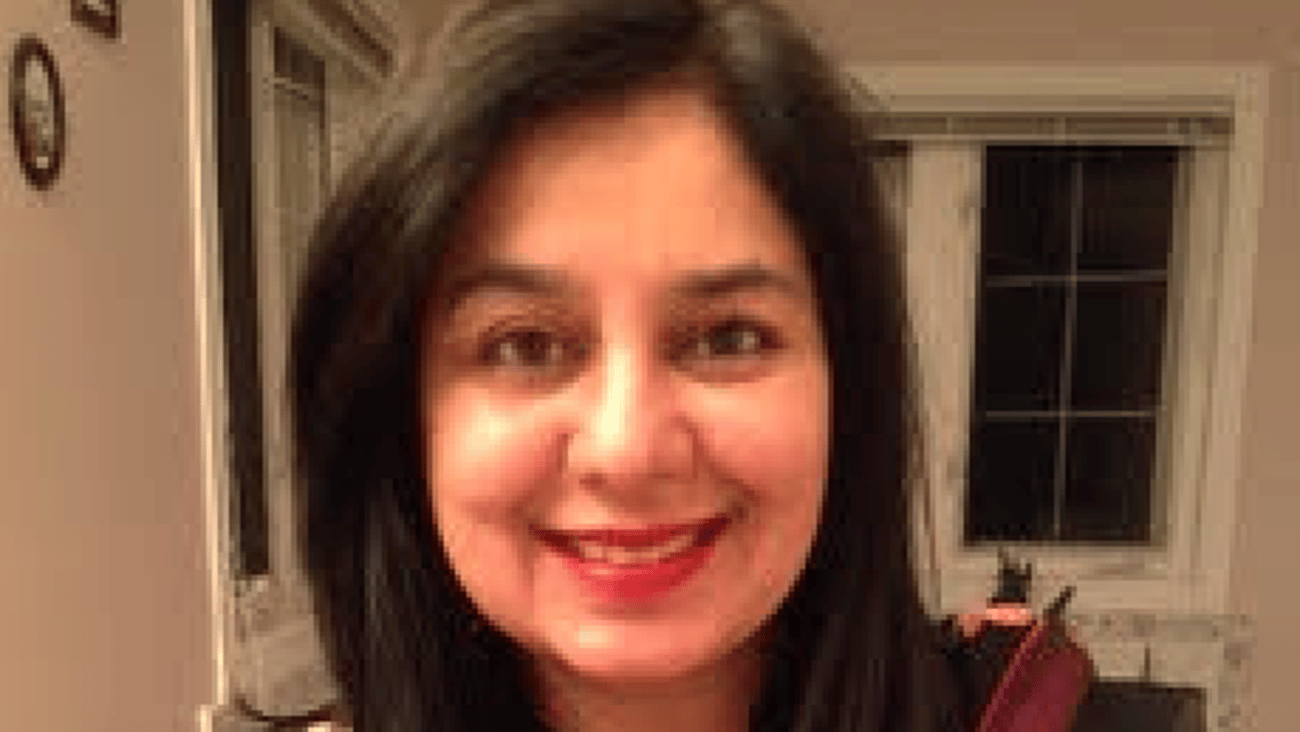 Dr. Ferrukh Faruqui smiling in her home