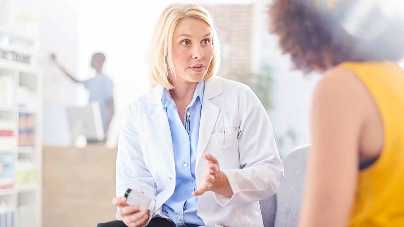 Pharmacist with customer in consultation