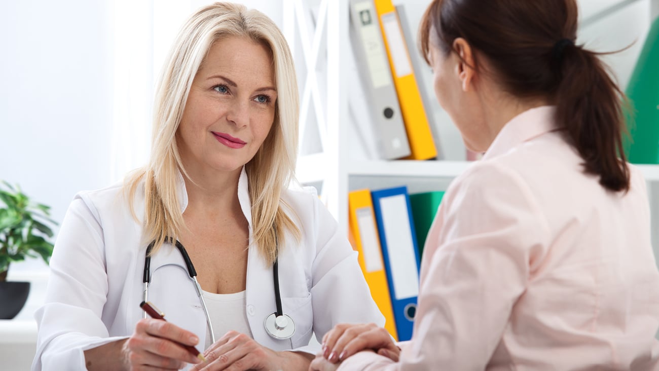 Patient in the doctor's office, she is receiving prescription medicine