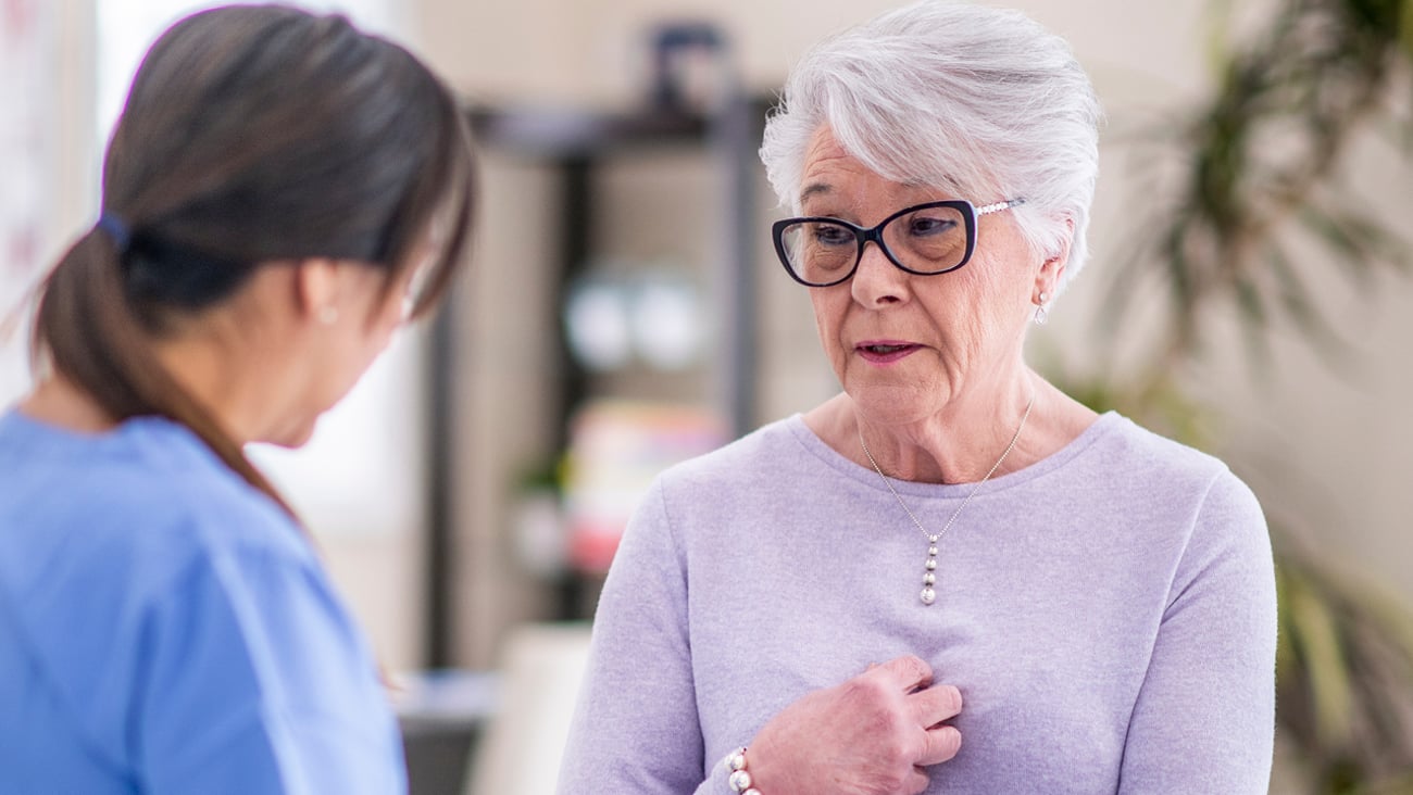 Older woman discussing her medication with her pharmacist