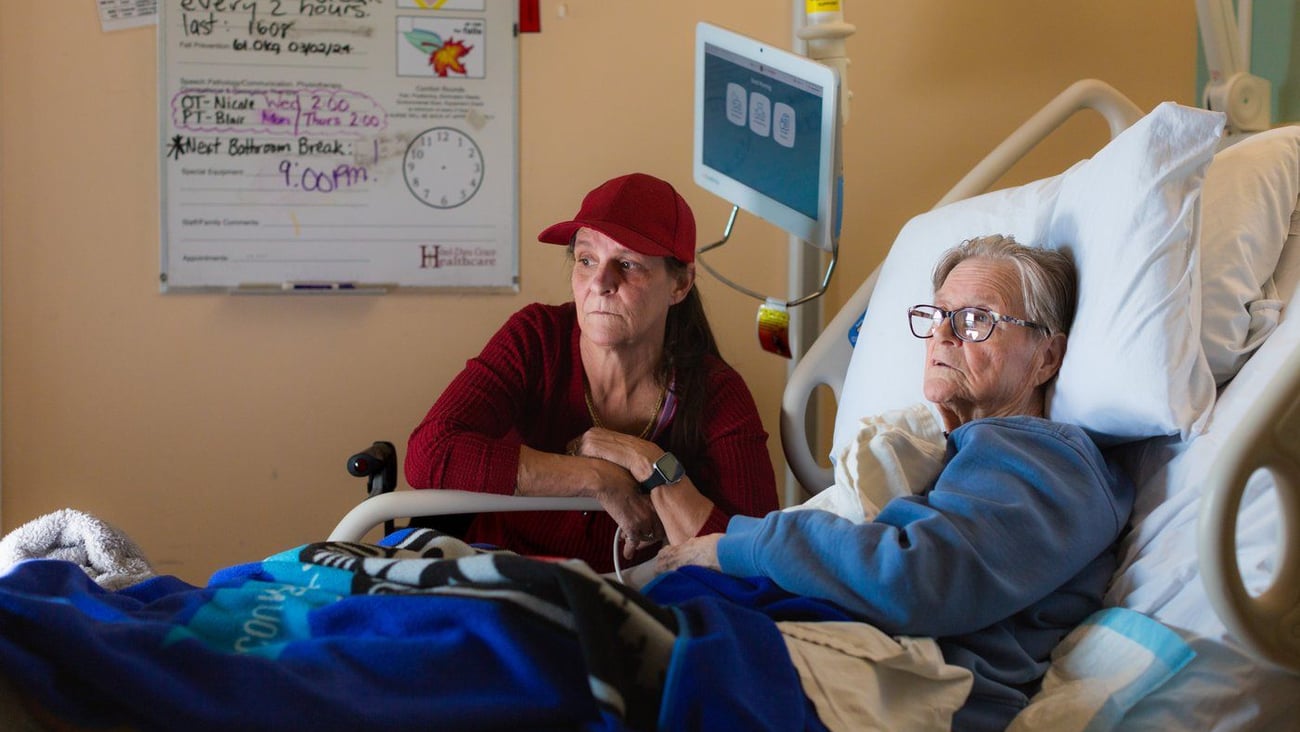 Woman in hospital bed.