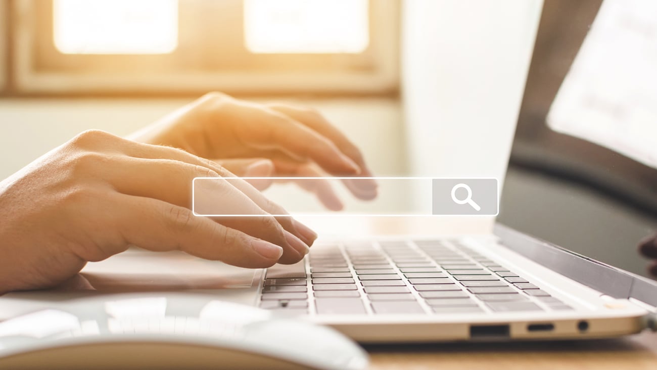 A pharmacist searching for details on deprescribing using a laptop