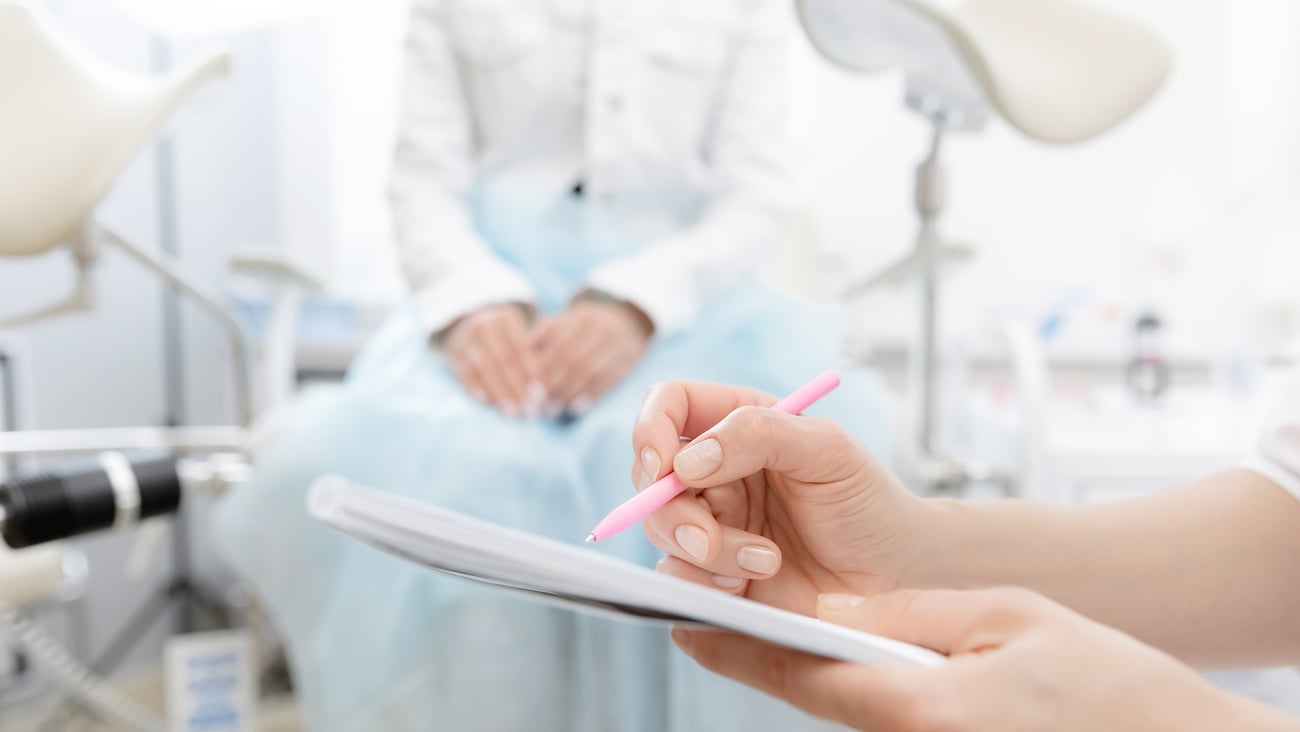 Young woman patient at gynecologist appointment consults in medical institution.