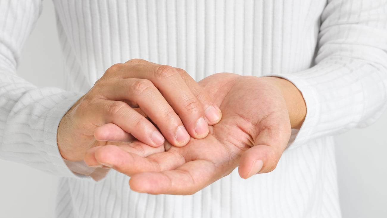 person holding their sore or numb hands together