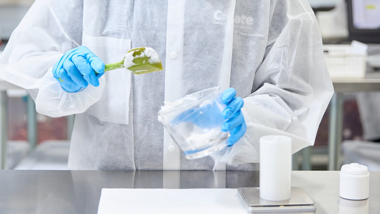 The hands of a pharmacist working in compounding medications