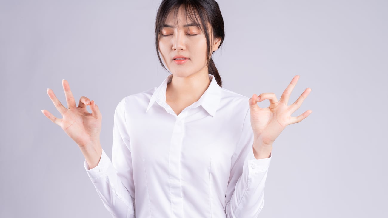 Young asian woman doing breathing exercise