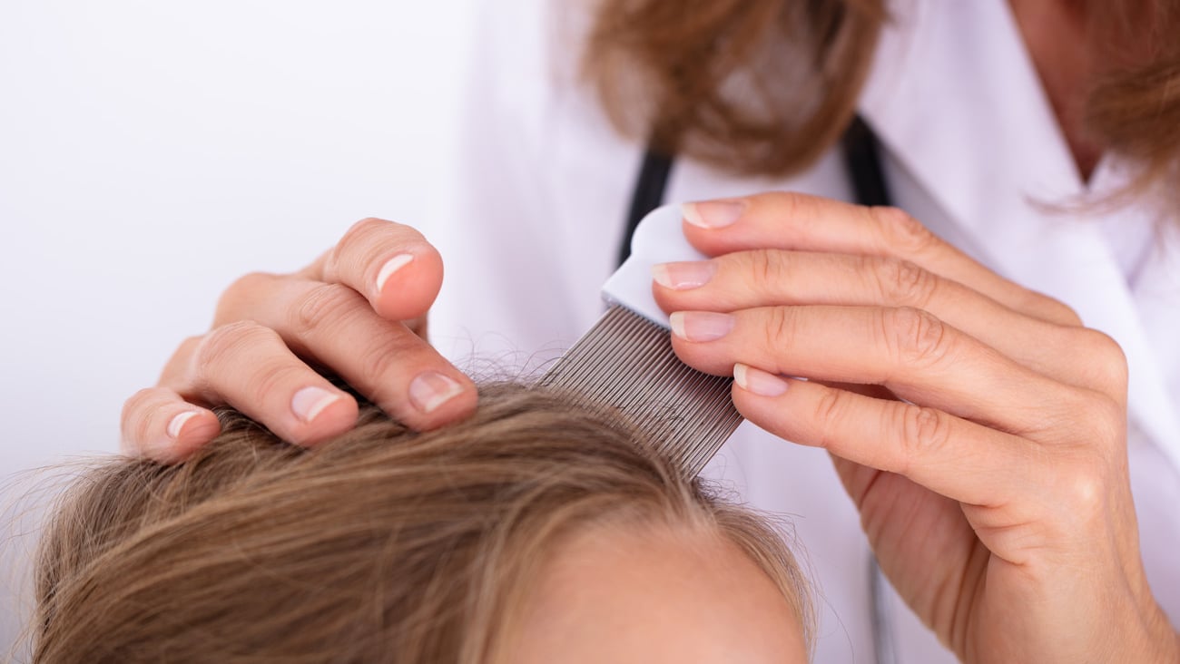 Female healthcare professional evaluating a woman's scalp