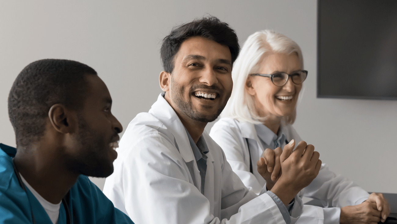 smiling healthcare workers at a table