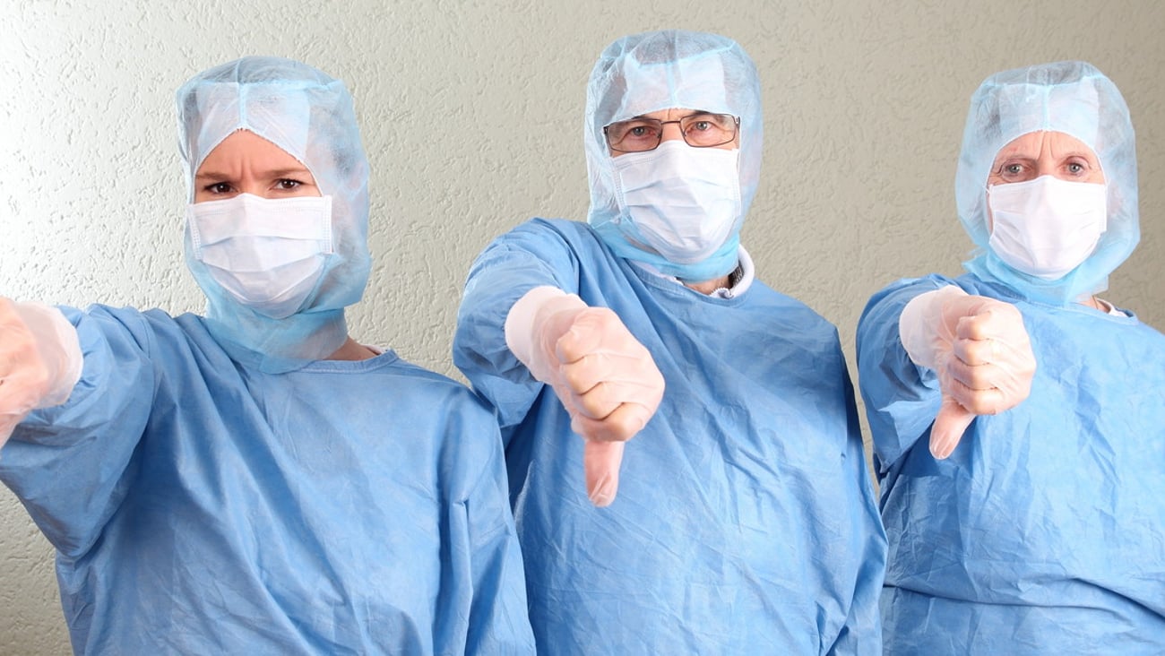 Three Doctors with thumbs down; Shutterstock ID 270405080