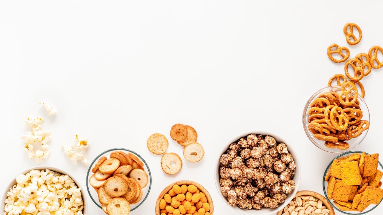 Set of many salty snacks in bowls - pretzels nuts chips top view.; Shutterstock ID 2313723267