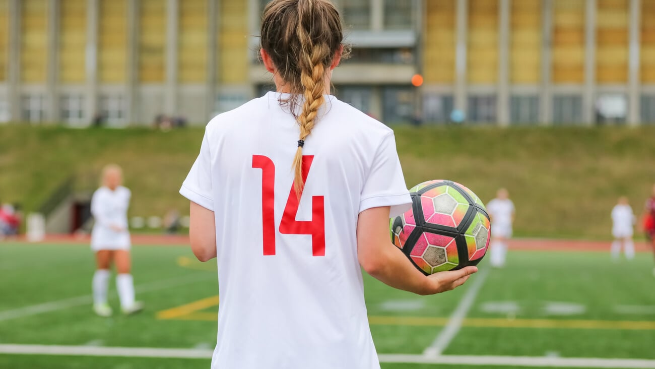 A female soccer athlete gets ready to inbound the ball; Shutterstock ID 1191928786