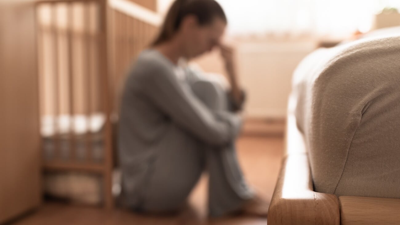 Tired, exhausted, mother, wife at home sitting on bedroom floor. ; Shutterstock ID 2192833021