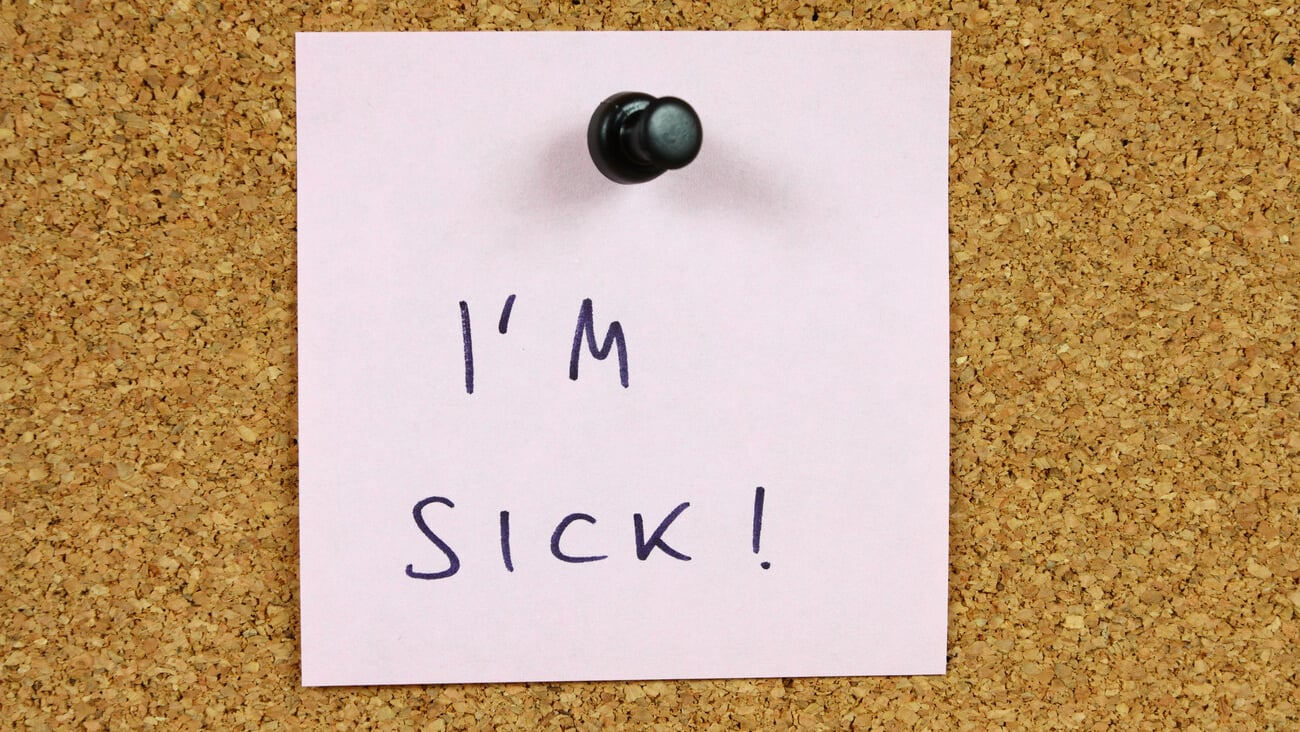 Office message, sticky note pinned to a bulletin board. I'm sick - sickness leave.; Shutterstock ID 63447253