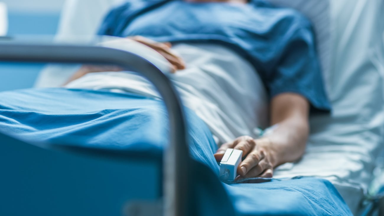 In the Hospital Sick Male Patient Sleeps on the Bed. Heart Rate Monitor Equipment is on His Finger.; Shutterstock ID 1190997985