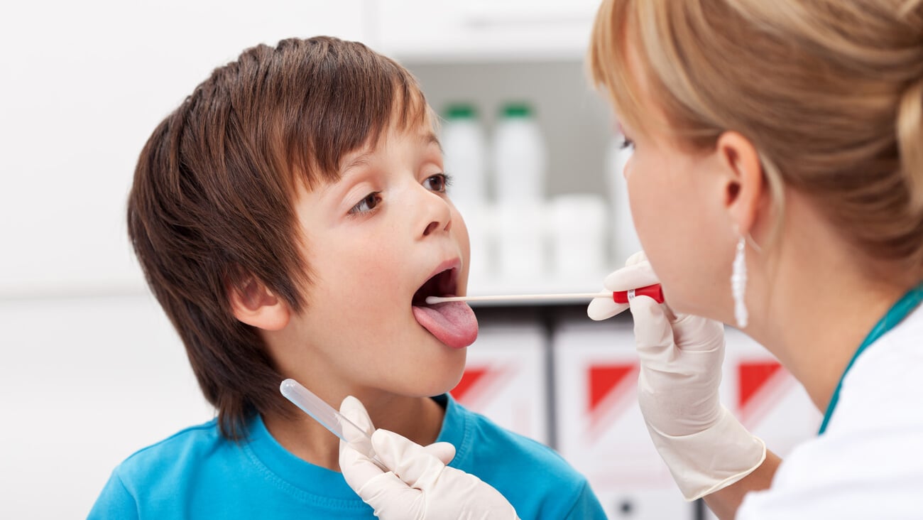 Boy at the doctor - a healthcare professional taking biological samples for testing; Shutterstock ID 171306479