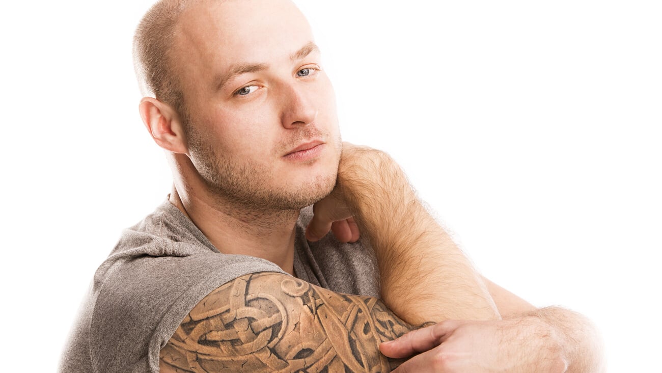 Handsome young man with tattoo, isolated on white.; Shutterstock ID 172367090