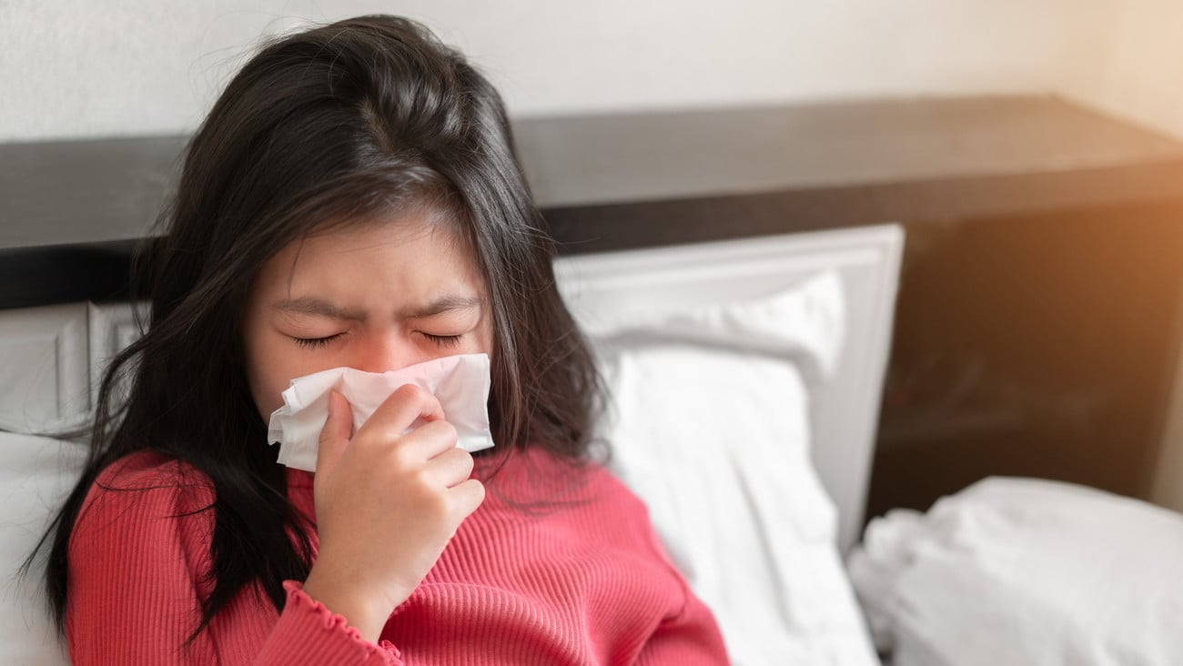 Sick asian girl have hight fever flu and sneezing into tissue on bed in bedroom, Healthcare and prevent the spread infection virus concept, Selective focus.; Shutterstock ID 1800983917