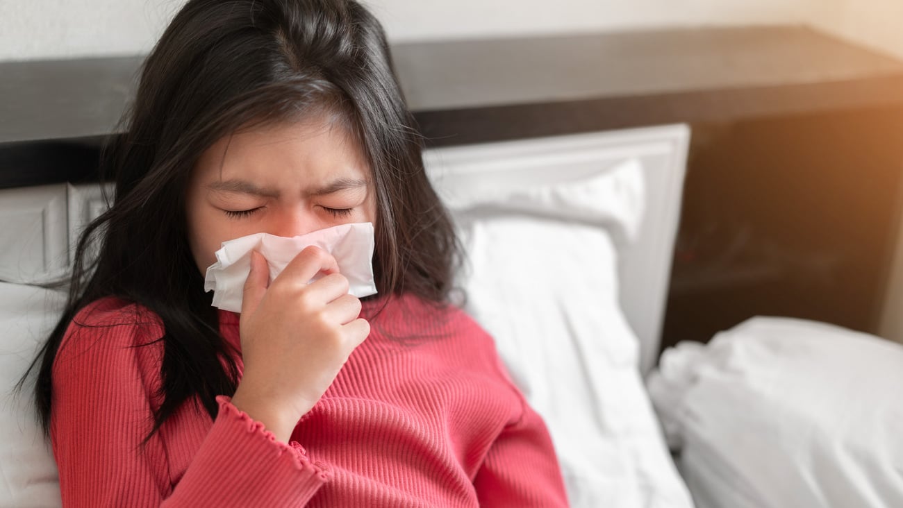 Sick asian girl have hight fever flu and sneezing into tissue on bed in bedroom, Healthcare and prevent the spread infection virus concept, Selective focus.; Shutterstock ID 1800983917