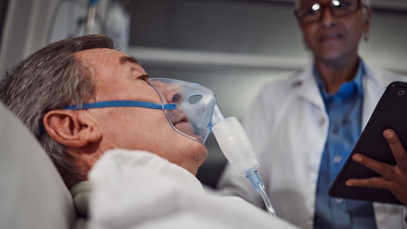 Oxygen mask, healthcare and senior man in the hospital after a surgery, treatment or medical procedure. Recovery, bed and elderly male patient in a consultation with a surgeon or doctor at a clinic.; Shutterstock ID 2261771969