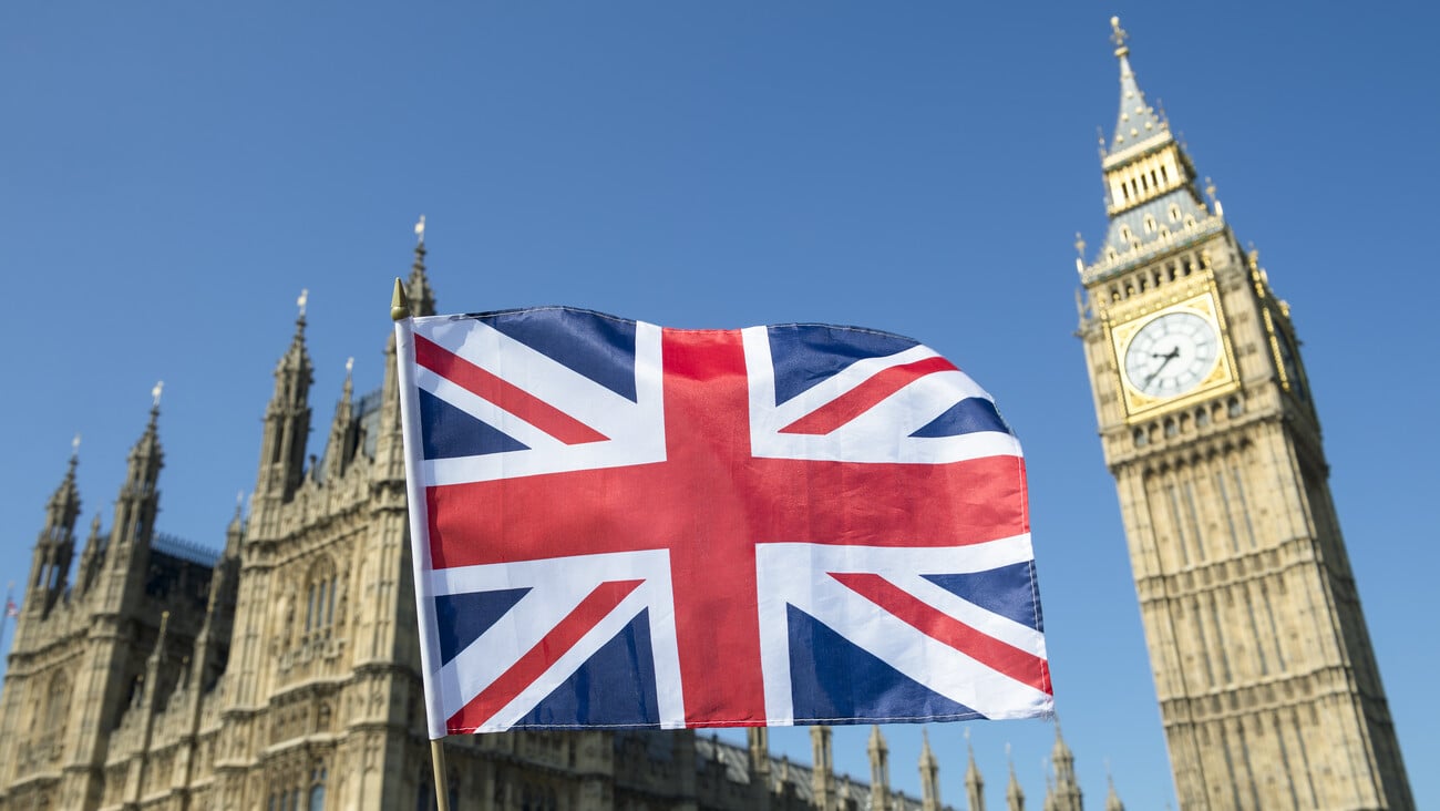 Great British Union Jack flag flying in front of Big Ben and the Houses of Parliament at Westminster Palace, London, a symbol of national pride during the EU Brexit and election proceedings; Shutterstock ID 433815025