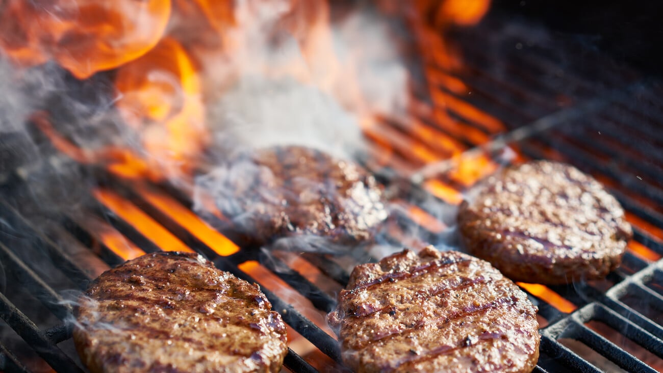 cooking burgers on hot grill with flames; Shutterstock ID 504951676