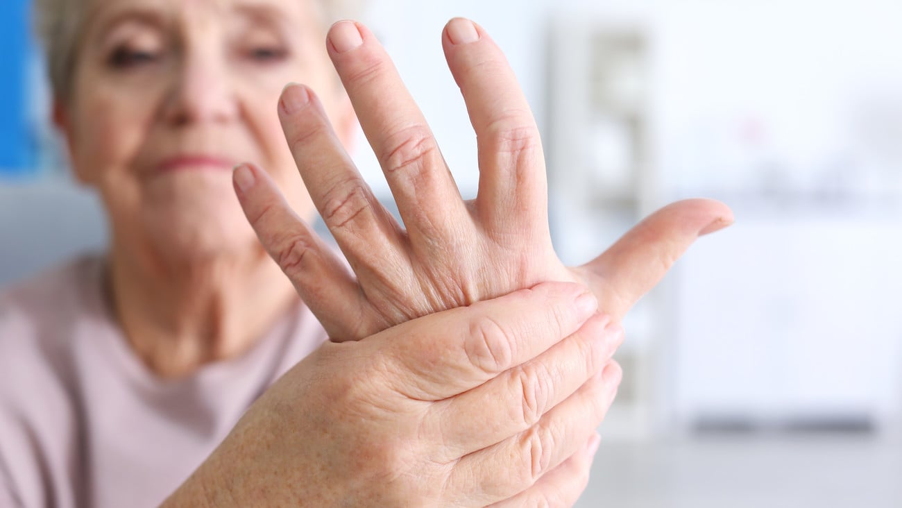 Elderly woman suffering from pain in hand, closeup; Shutterstock ID 566470942