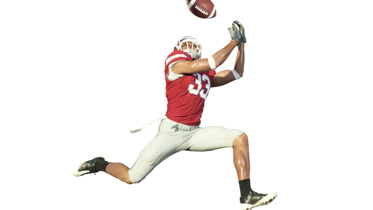 football player catches ball in midair; Shutterstock ID 65328784