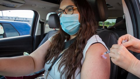 a woman wearing sunglasses driving a car