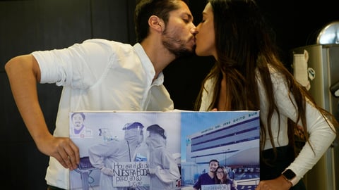 Doctor David Vallejo and his fiancee Doctor Mavelin Bonilla hold photos of themselves working
