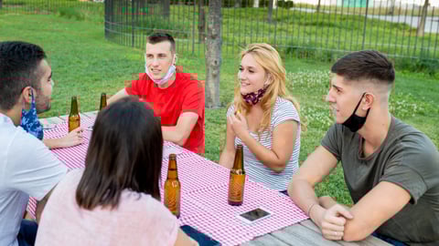 a group of people sitting at a picnic table