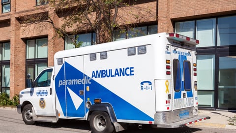 a blue truck parked on the side of a building