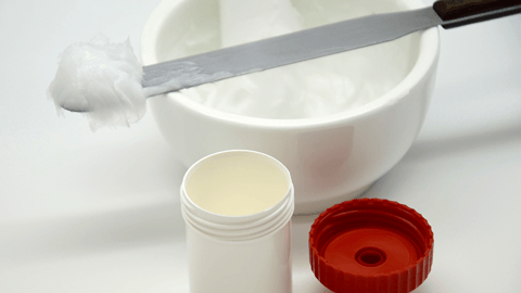 scooping cream out of a pharmacist's mortar and pestle