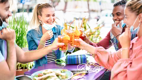 a group of people sitting at a table eating food