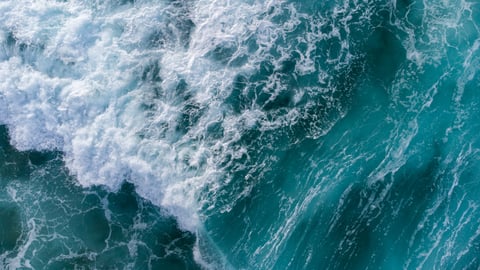 a person riding a wave on a surfboard in the ocean