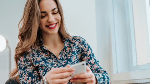 a woman holding a cell phone