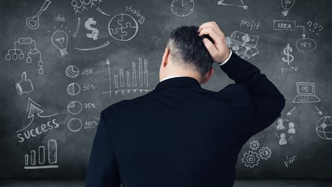 a man standing in front of a blackboard