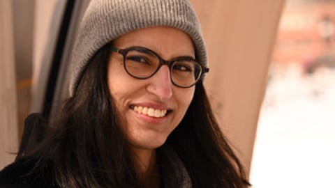 a woman wearing a hat and glasses