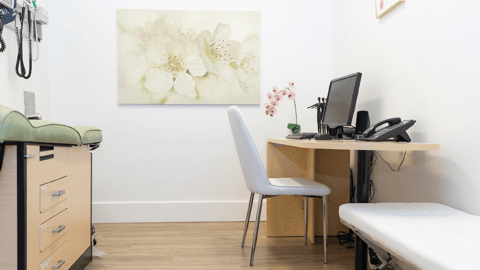 a bedroom with a bed and desk in a room