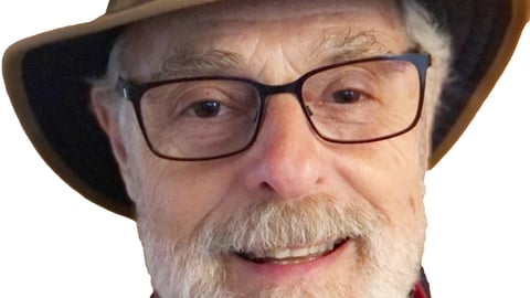 a close up of a man wearing a hat and glasses