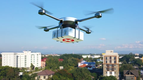 a small airplane flying over a city