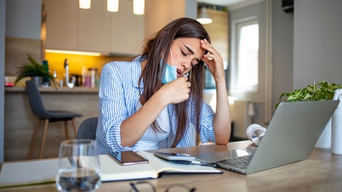 a woman sitting at a table using a laptop