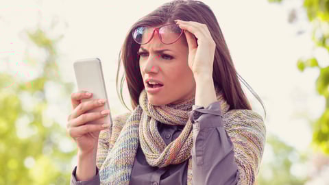 a woman wearing a hat talking on a cell phone