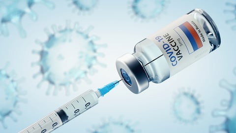 COVID-19 vaccine with syringe in vial