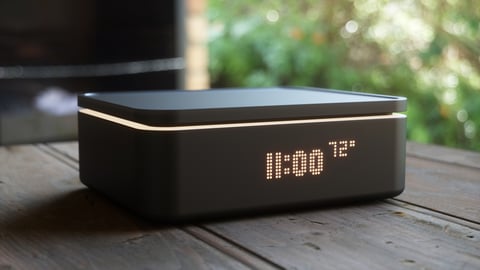 a laptop computer sitting on top of a wooden table