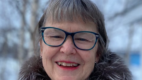 a close up of a person wearing glasses